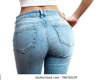 Woman wearing of jean pants from back. Female bottom in tight jeans