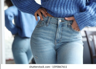 Woman Wearing Jeans Near Mirror Indoors, Closeup