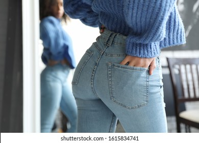 Woman Wearing Jeans Near Mirror Indoors, Closeup