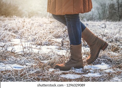 Woman wearing leather hiking boots in winter frozen nature. Walking in snowy footpath - Powered by Shutterstock