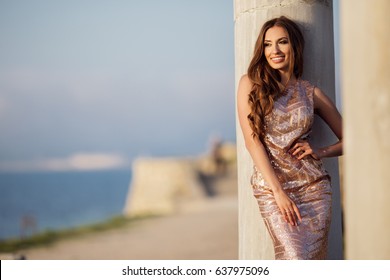 Woman Is Wearing Luxury Dress Near Antique Column