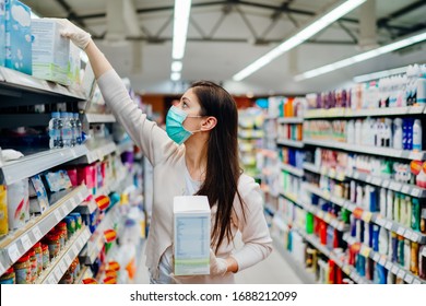 Woman Wearing Mask And Gloves Buying Baby Formula Due To Covid-19 Or Coronavirus And Panic Buying.Preparation For A Pandemic Quarantine.Shopping For Infant Formula,baby Food Supply Shortage.Hoarding