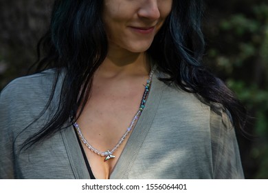 Woman Wearing Mineral Stone Mala Necklace With Wale Tale Silver Pendant