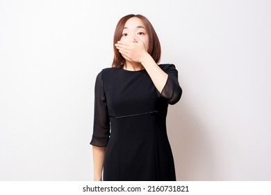 A Woman Wearing A Mourning Dress, Hiding Her Mouth With Her Hands