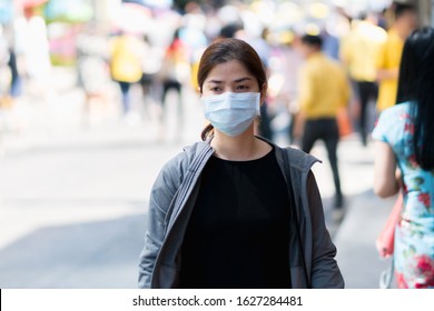A woman wearing mouth mask against air smog pollution PM 2.5 and Coronavirus in the community at Bangkok in Thailand 2020. - Shutterstock ID 1627284481