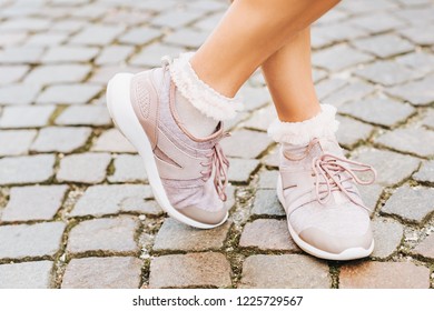 Woman Wearing New Comfy Trainers And Soft Pink Ruffle Socks, Close Up Image