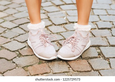 Woman Wearing New Comfy Trainers And Soft Pink Ruffle Socks, Close Up Image