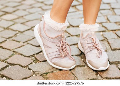 Woman Wearing New Comfy Trainers And Soft Pink Ruffle Socks, Close Up Image