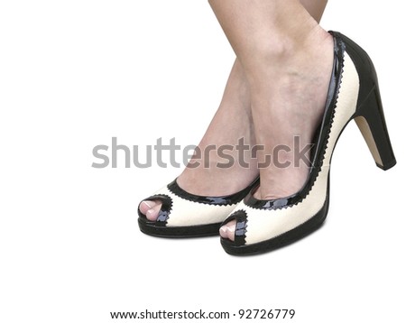 A woman wearing a pair of black & white classic high heels with clipping path.