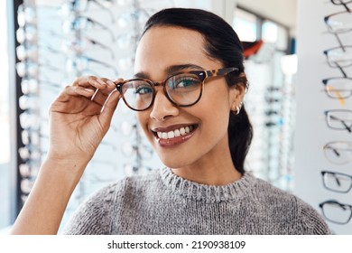 Woman wearing pair of trendy glasses, stylish spectacles and new prescription lenses at an optometrist. Portrait of a customer choosing, buying and shopping for frames for better vision and eyesight - Shutterstock ID 2190938109