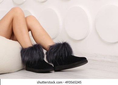 Woman wearing a pair of winter suede shoes. Fashionable shoe suede products. Women's shoes wearing on his feet.
