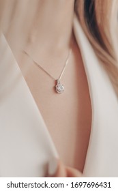 Woman Wearing Pendant Necklace With Diamond On Close-up