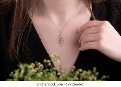 Woman Wearing Pendant Necklace With Diamond On Close-up