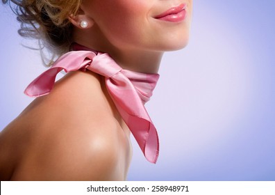 Woman wearing pink scarf.