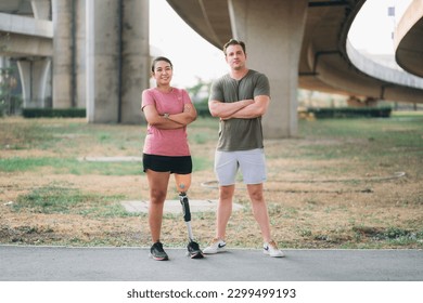 Woman wearing prosthetic equipment exercise outdoors with friend in a park.  - Powered by Shutterstock