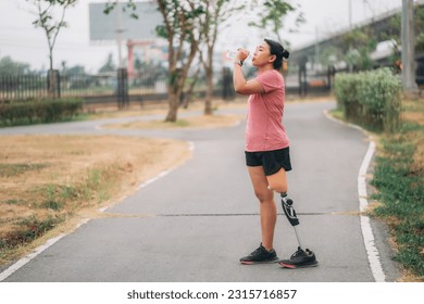 Woman wearing prosthetic equipment sit down after exercising in a park. Female walking and exercise works out outside. - Powered by Shutterstock