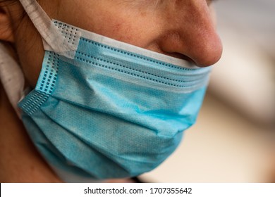 Woman wearing a protective face mask against the coronavirus or Covid-19 in the incorrect position without covering her nose