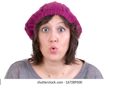 Woman Wearing A Purple Knitted Beanie Reacting In Amazement And Wonder Puckering Her Lips Into An Ooh Expression With Wide Eyes, On White