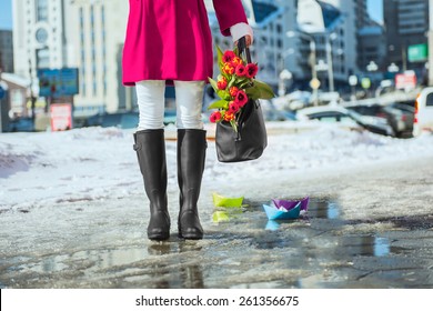 Woman Wearing Rain Boots Stay Into A Puddle