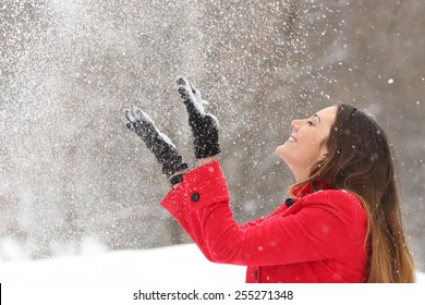 Woman Wearing A Red Jacket Throwing Snow In The Air In Winter Holidays