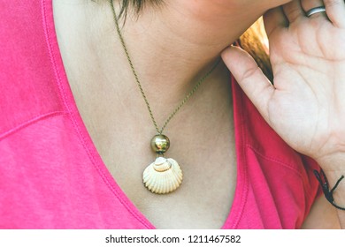 woman wearing shell component necklace