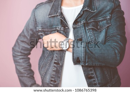 Similar – Frau mit Jeansjacke, blauer Bluse und silberner Armbanduhr.