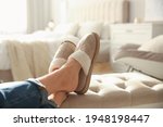Woman wearing soft comfortable slippers at home, closeup