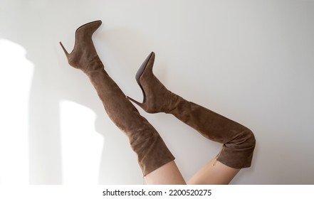 Woman Wearing Stylish Brown Suede Female High Boot With High Heel.