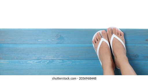 Woman wearing stylish flip flops on turquoise wooden deck against white background, top view