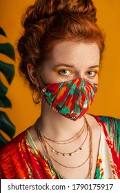 Woman Wearing Stylish Outfit With Designer Protective Bold Colorful Face Mask, Matching Dress, Chain Necklace. Trendy Fashion Accessory During Quarantine. 