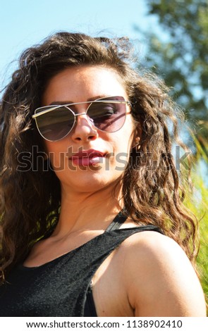 Similar – Woman with sunglasses looking at camera over garden fence