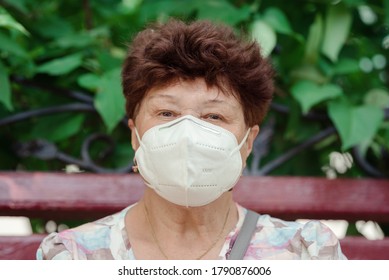 Woman Wearing Surgical Mask Epidemic Prevention Covering Face. Senior Woman In Late 60s Using Mask Looking To Camera.