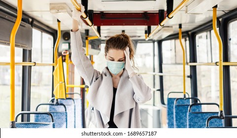 Woman Wearing Surgical Protective Mask Having A Headache In A Public Transportation