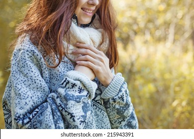 woman wearing sweater (soft focus on her hands)