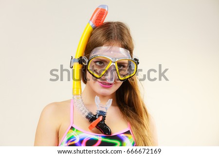 Woman wearing swimsuit with snorkeling mask having fun studio shot, Happy joyful girl dreaming about active summer vacation. Snorkeling swimming concept