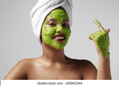 Woman Wearing A Towel And Avocado Facial Mask