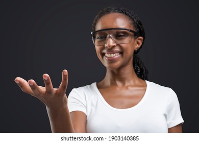 Woman Wearing Transparent Goggles Showing Invisible Object