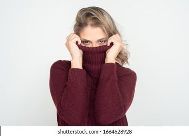 Woman wearing turtleneck and looking at camera. Attractive young blonde woman wearing maroon turtleneck and looking at camera isolated on white background. Beauty concept - Shutterstock ID 1664628928