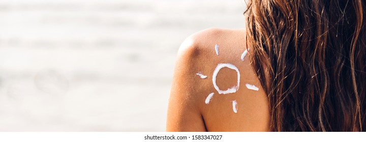 Woman Wearing Two Piece Bikini Applying Suncream With Sun Drawn On Back On The Tropical Beach.Summer Vacations