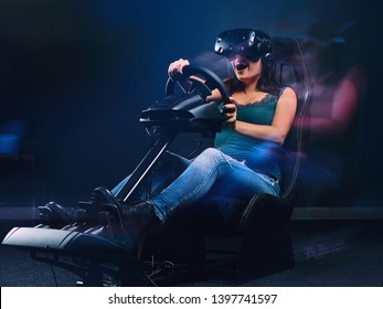 Woman wearing VR headset having fun while driving on car racing simulator cockpit with seat and wheel. - Shutterstock ID 1397741597