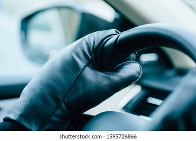 Woman Wearing Warm Mittens Gloves While Holding The Steering Wheel Of A Car On A Winter Cold Day