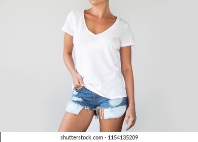 Woman wearing a white cotton shirt with empty space for your text or logo isolated on gray background