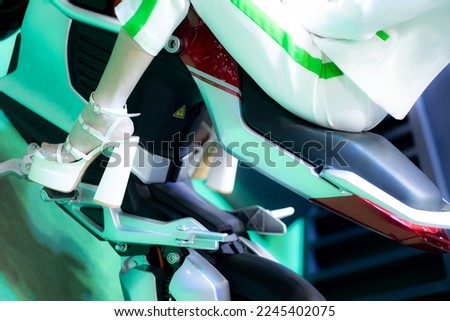 Woman wearing white high heels rides on modern motorcycle.