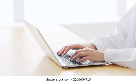 Woman wearing white robe working in the room. - Powered by Shutterstock