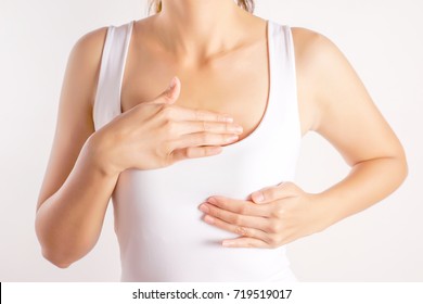 Woman Wearing A White Tank Top Checking Her Breast, Breast Self-Exam (BSE), How do I check breast concept, Breast Cancer Awareness