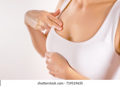 Woman Wearing A White Tank Top Checking Her Breast, Breast Self-Exam (BSE), How do I check breast concept, Breast Cancer Awareness