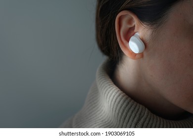 Woman Wearing White Wireless Earbuds