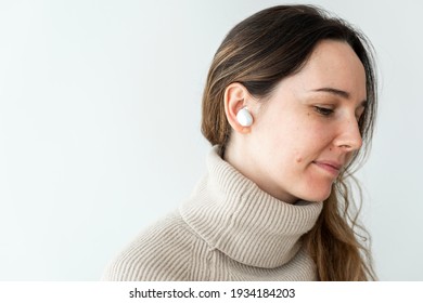 Woman Wearing White Wireless Earbuds