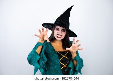 Woman Wearing Witch Costume Over Isolated White Background Smiling Funny Doing Claw Gesture As Cat, Aggressive And Sexy Expression