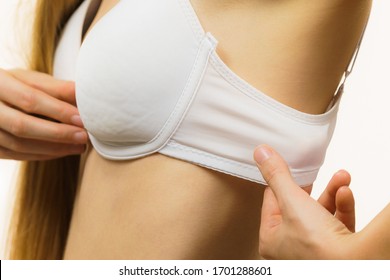 Woman wearing wrong bra, underbust band too wide. Female breast in lingerie. Measure bra size, fitting concept.